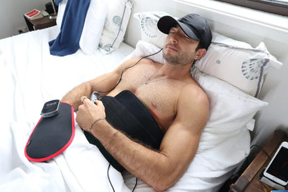 Man reclining with the HeroBelt wrapped around his abdomen