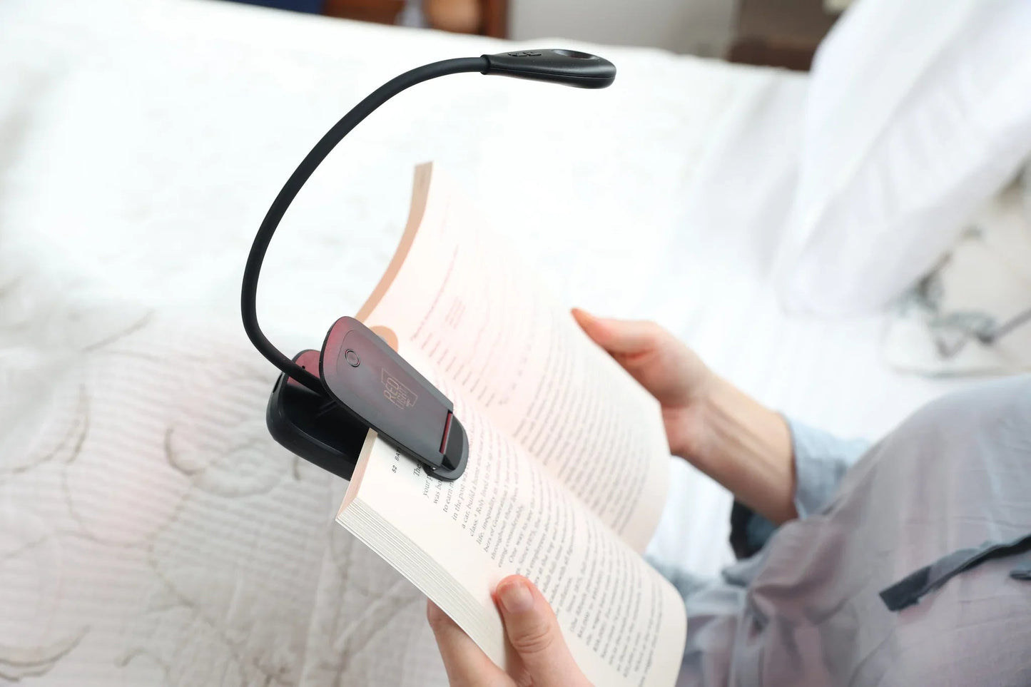 Close-up of the HeroReader lamp clipped to an open book