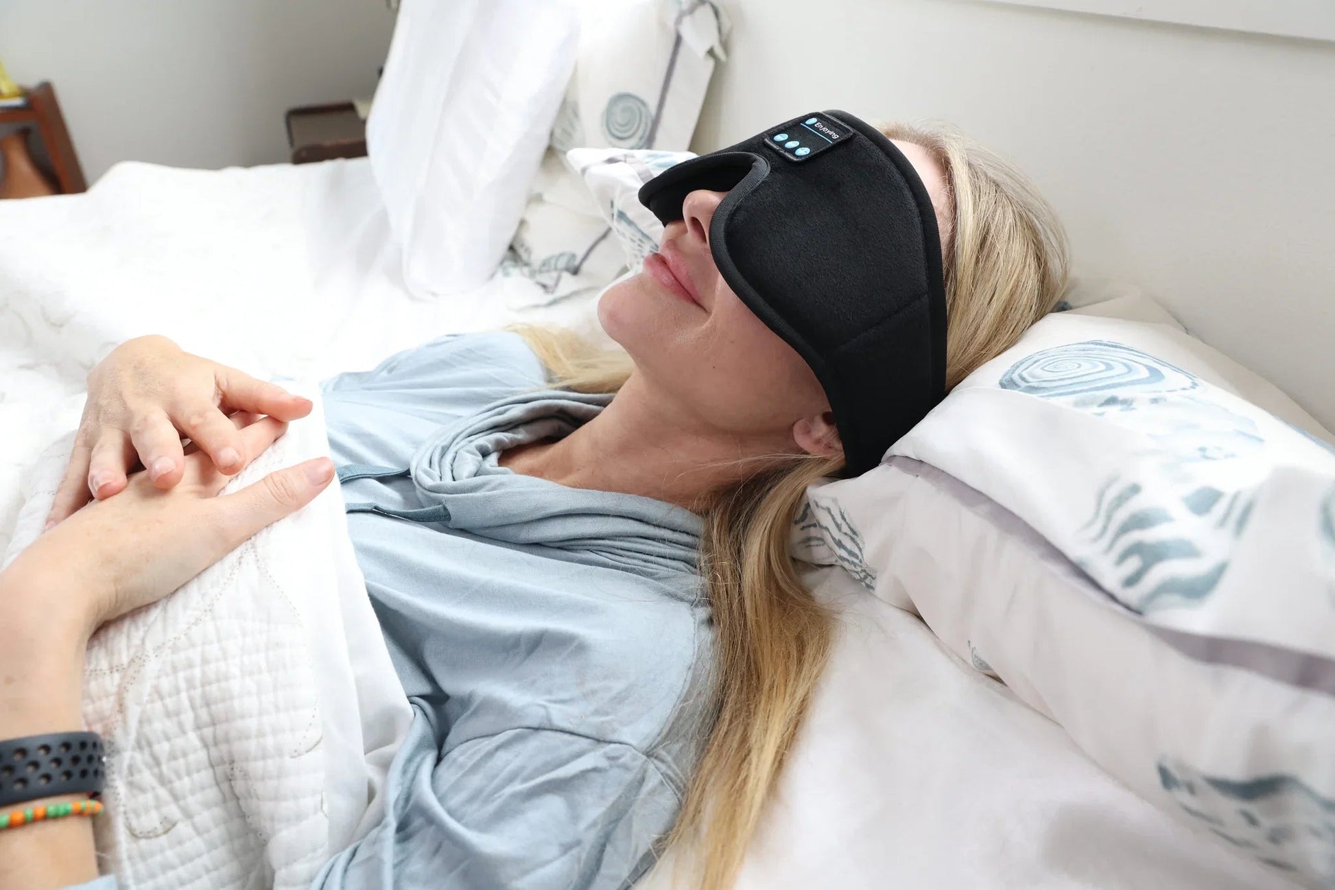 Woman lying on her side wearing the HeroSleep Soothe sleep mask