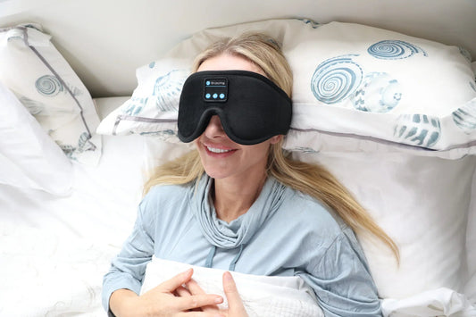 Woman lying in bed wearing the HeroSleep Soothe sleep mask