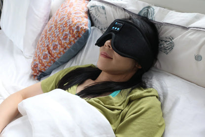 Woman resting under covers with the HeroSleep Soothe sleep mask