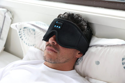 Man resting in bed wearing the HeroSleep Soothe sleep mask