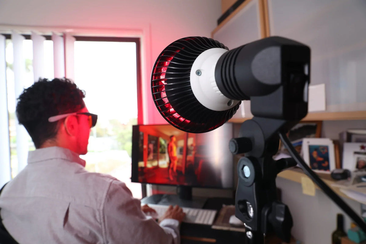 HeroSpotlight lamp on a stand directed at a man's back