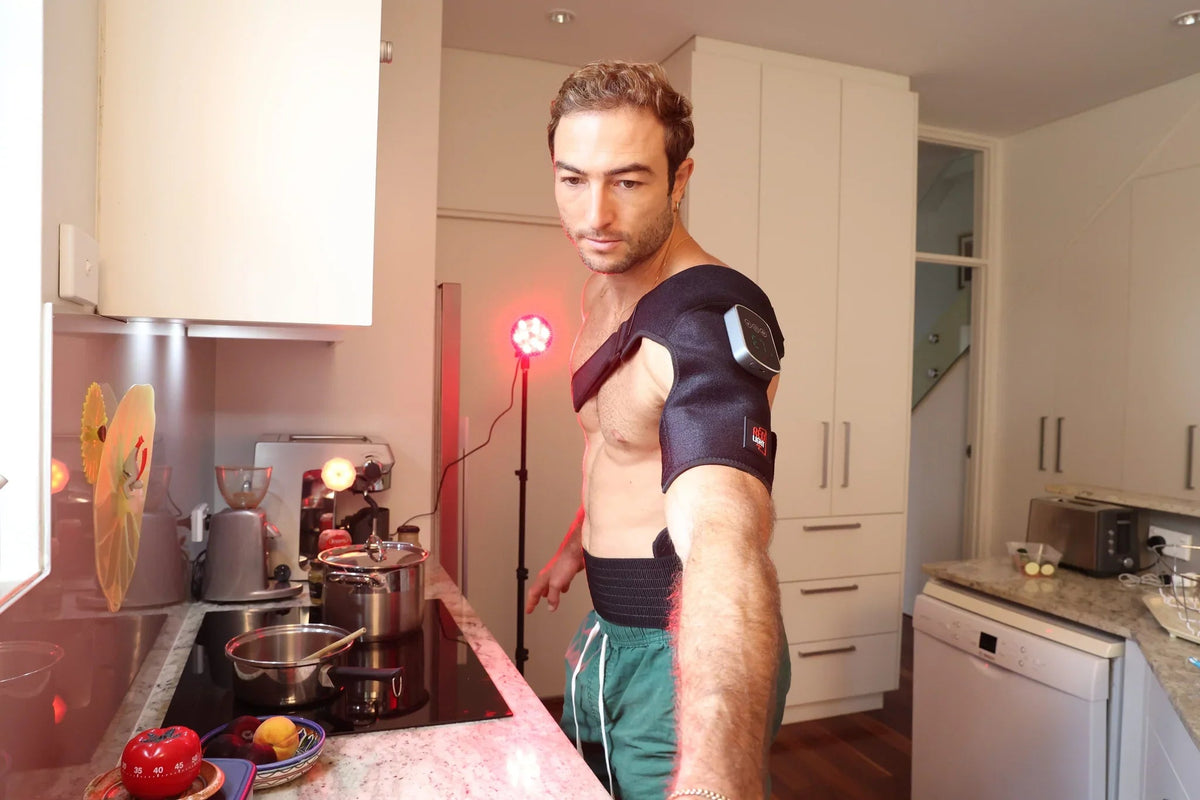 Man using a HeroSpotlight lamp on his shoulder while cooking