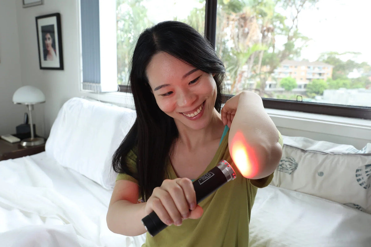 Woman applying the HeroTorch to her elbow