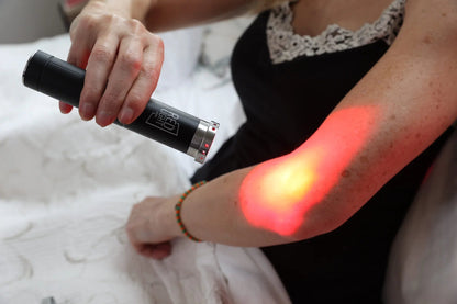 Woman applying red light from the HeroTorch to her forearm