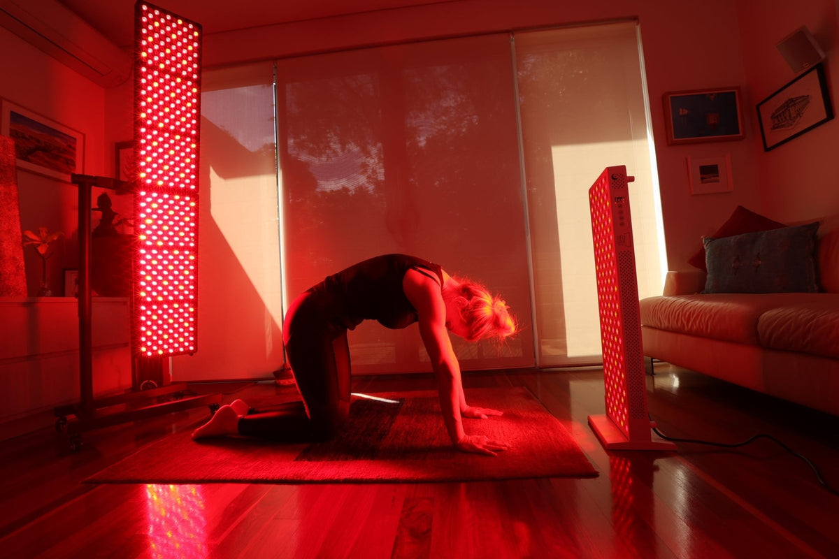 Woman in a tabletop yoga pose between two Hero300 panels