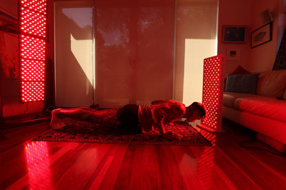 Woman in child’s pose between two Hero300 panels